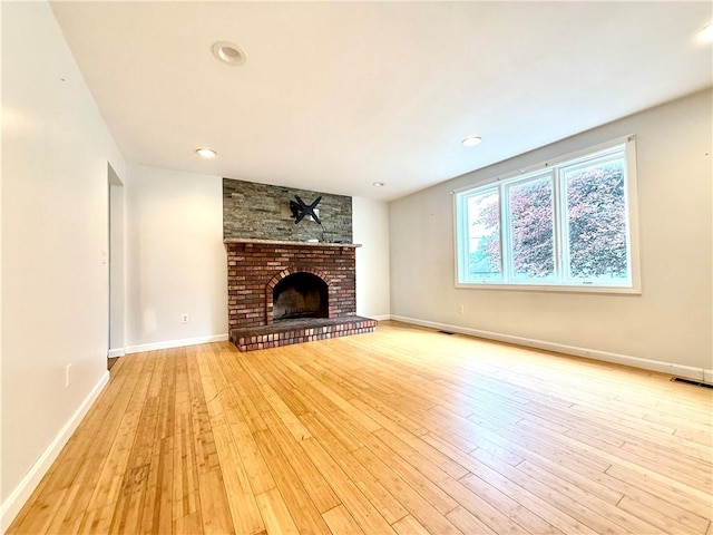 74 Plymouth Rd, East Providence, RI 02914 - unfurnished living room with wood-type flooring, a fireplace, and recessed lighting