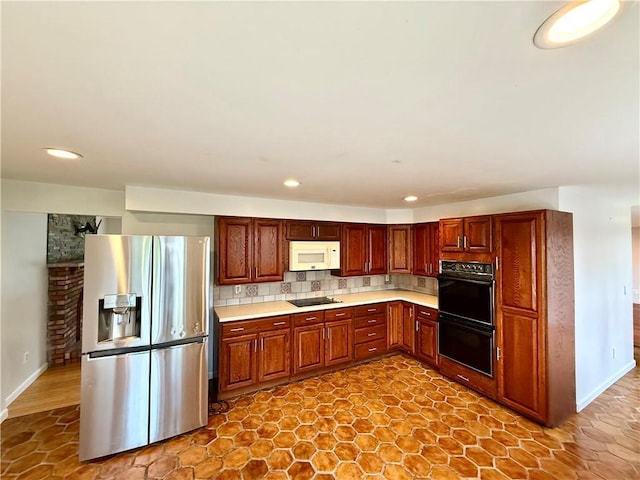 74 Plymouth Rd, East Providence, RI 02914 - kitchen with black appliances, light countertops, backsplash, and recessed lighting