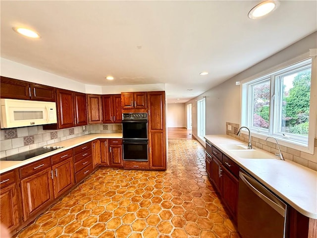 74 Plymouth Rd, East Providence, RI 02914 - kitchen featuring black appliances, recessed lighting, tasteful backsplash, and light countertops