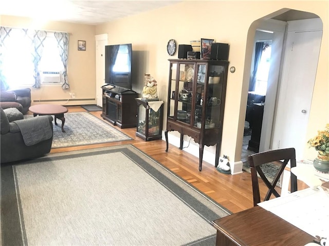 16 Edgemere Rd, Pawtucket, RI 02861 - living room with arched walkways, a baseboard radiator, wood finished floors, and cooling unit