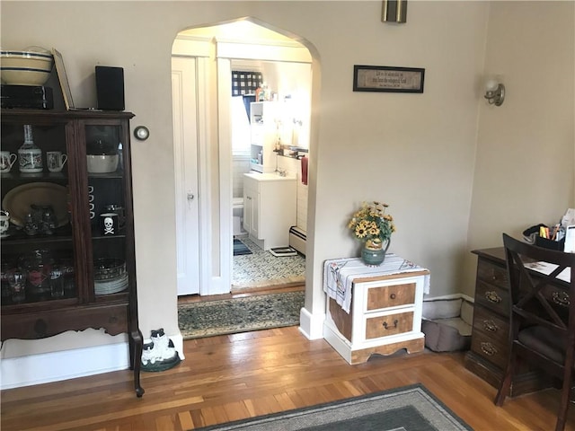 16 Edgemere Rd, Pawtucket, RI 02861 - corridor featuring arched walkways, wood finished floors, and baseboard heating