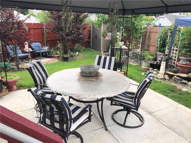16 Edgemere Rd, Pawtucket, RI 02861 - fenced backyard featuring outdoor dining space, a patio, and a gazebo