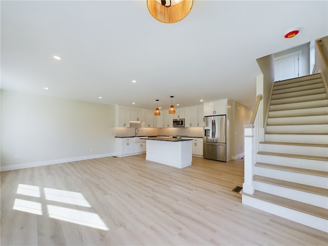 7 Carolina Nooseneck Rd Unit C, Richmond, RI 02898 - unfurnished living room featuring stairs, light wood-type flooring, and recessed lighting