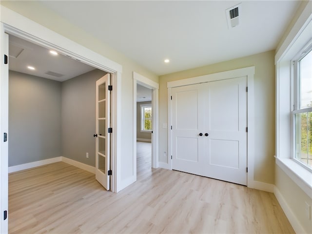 7 Carolina Nooseneck Rd Unit C, Richmond, RI 02898 - unfurnished bedroom with light wood-style floors, multiple windows, recessed lighting, and a closet