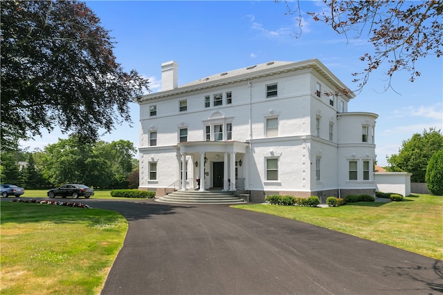 519 Bellevue Ave Unit 2N, Newport, RI 02840 - view of front of house featuring a chimney, a front lawn, and stucco siding