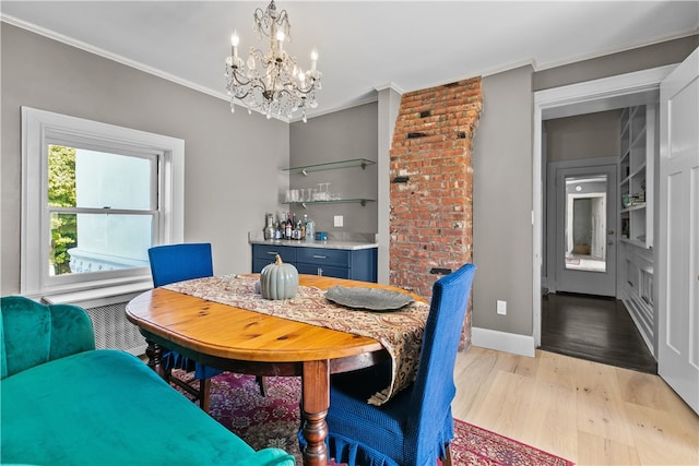 519 Bellevue Ave Unit 2N, Newport, RI 02840 - dining room with a chandelier, light wood-style flooring, crown molding, and a dry bar