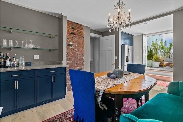 519 Bellevue Ave Unit 2N, Newport, RI 02840 - dining space with light wood-style floors, a chandelier, a dry bar, and crown molding