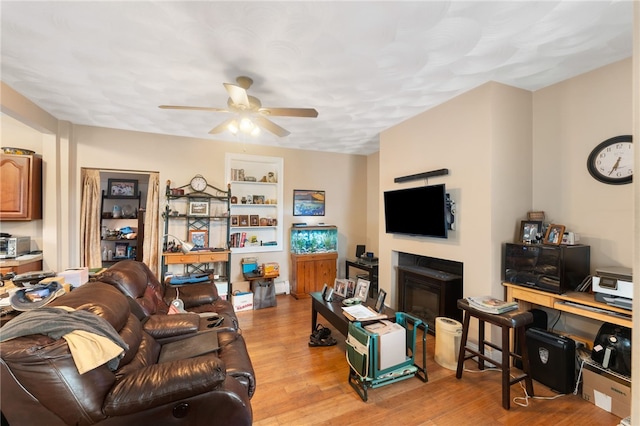 18 N Main St, Coventry, RI 02816 - living area with a ceiling fan, light wood-style flooring, and a glass covered fireplace