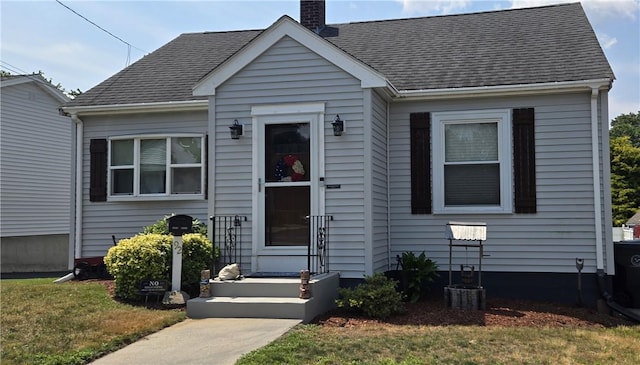 92 Silver Spring Ave, East Providence, RI 02915 - bungalow-style home with a chimney, a shingled roof, and a front lawn