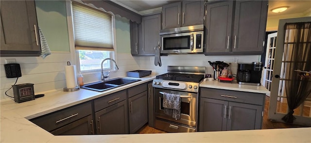 92 Silver Spring Ave, East Providence, RI 02915 - kitchen featuring appliances with stainless steel finishes, crown molding, light countertops, and decorative backsplash