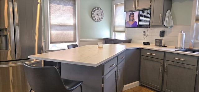 92 Silver Spring Ave, East Providence, RI 02915 - kitchen featuring gray cabinets, stainless steel refrigerator with ice dispenser, and plenty of natural light