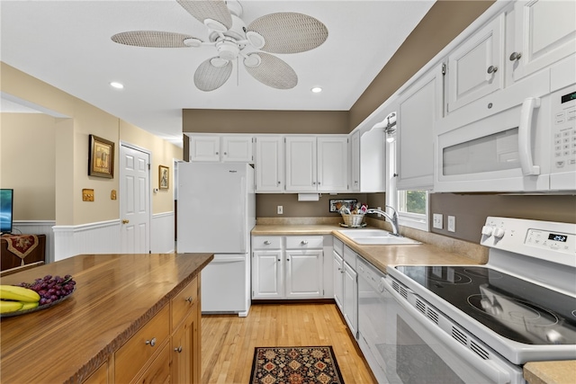 435 Allen Ave, South Kingstown, RI 02879 - kitchen with white appliances, light wood-type flooring, ceiling fan, white cabinets, and a wainscoted wall