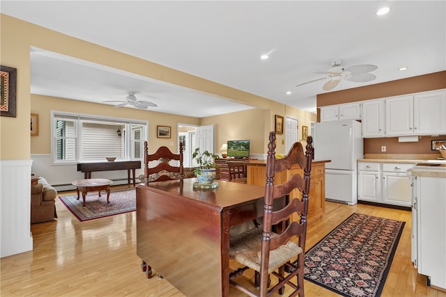 435 Allen Ave, South Kingstown, RI 02879 - dining area featuring a ceiling fan, light wood-type flooring, a wainscoted wall, a baseboard heating unit, and recessed lighting