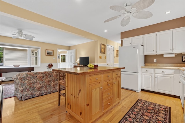 435 Allen Ave, South Kingstown, RI 02879 - kitchen with freestanding refrigerator, ceiling fan, light wood finished floors, a kitchen island, and recessed lighting