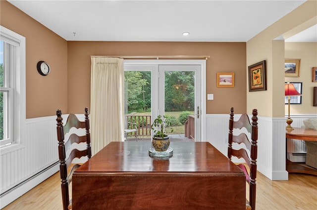 435 Allen Ave, South Kingstown, RI 02879 - dining area with a baseboard radiator, wainscoting, healthy amount of natural light, light wood finished floors, and baseboard heating