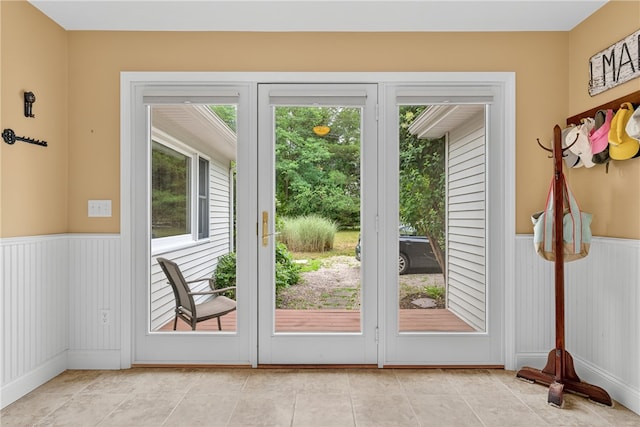 435 Allen Ave, South Kingstown, RI 02879 - doorway to outside featuring a wainscoted wall and light tile patterned flooring