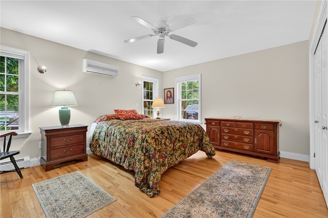 435 Allen Ave, South Kingstown, RI 02879 - bedroom with a wall mounted AC, light wood-style floors, baseboard heating, a closet, and a ceiling fan