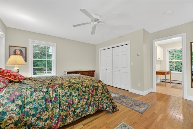 435 Allen Ave, South Kingstown, RI 02879 - bedroom featuring baseboard heating, wood finished floors, a ceiling fan, and a closet