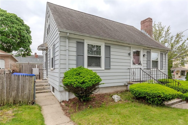 36 Walton St, Providence, RI 02908 - view of front of property with a chimney and roof with shingles