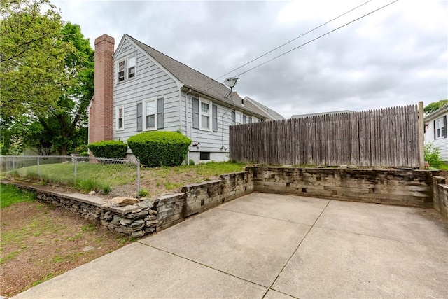 36 Walton St, Providence, RI 02908 - view of side of home featuring a patio area and a chimney