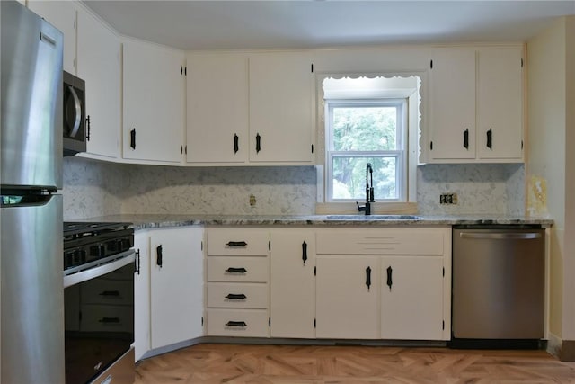 44 Cindy Ln, Warwick, RI 02886 - kitchen featuring stainless steel appliances, decorative backsplash, white cabinetry, and light stone countertops