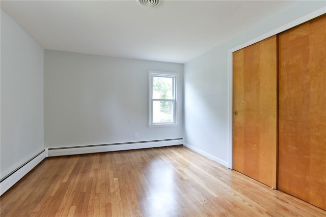 44 Cindy Ln, Warwick, RI 02886 - unfurnished bedroom featuring light wood finished floors, baseboard heating, and a closet