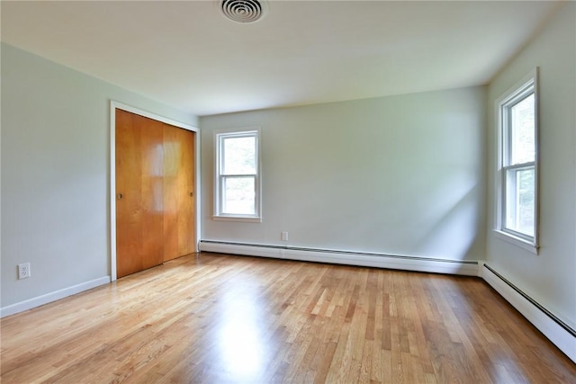 44 Cindy Ln, Warwick, RI 02886 - spare room with plenty of natural light, wood finished floors, and a baseboard radiator