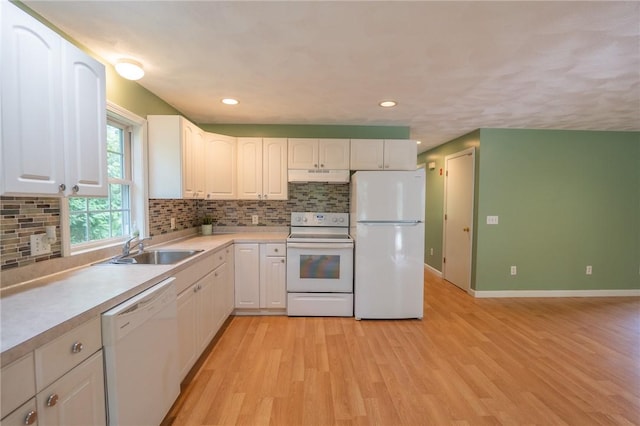196 William Henry Rd, Scituate, RI 02857 - kitchen with white appliances, under cabinet range hood, backsplash, light wood-type flooring, and white cabinetry