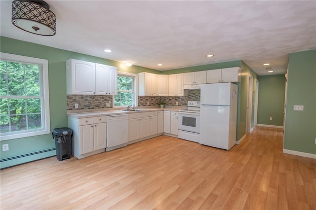 196 William Henry Rd, Scituate, RI 02857 - kitchen featuring white appliances, a baseboard radiator, light countertops, decorative backsplash, and recessed lighting