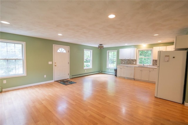 196 William Henry Rd, Scituate, RI 02857 - unfurnished living room featuring a baseboard radiator, light wood-type flooring, and recessed lighting