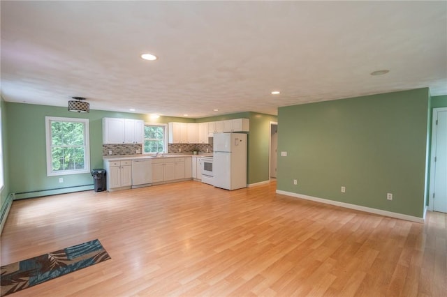 196 William Henry Rd, Scituate, RI 02857 - kitchen with white appliances, a baseboard radiator, light countertops, light wood finished floors, and backsplash