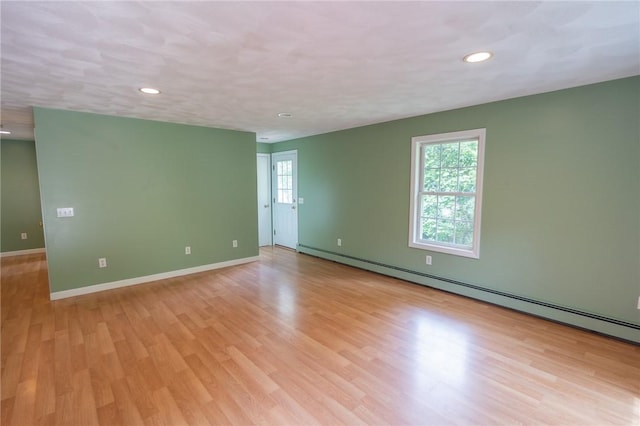 196 William Henry Rd, Scituate, RI 02857 - empty room featuring a baseboard heating unit, light wood-type flooring, and recessed lighting