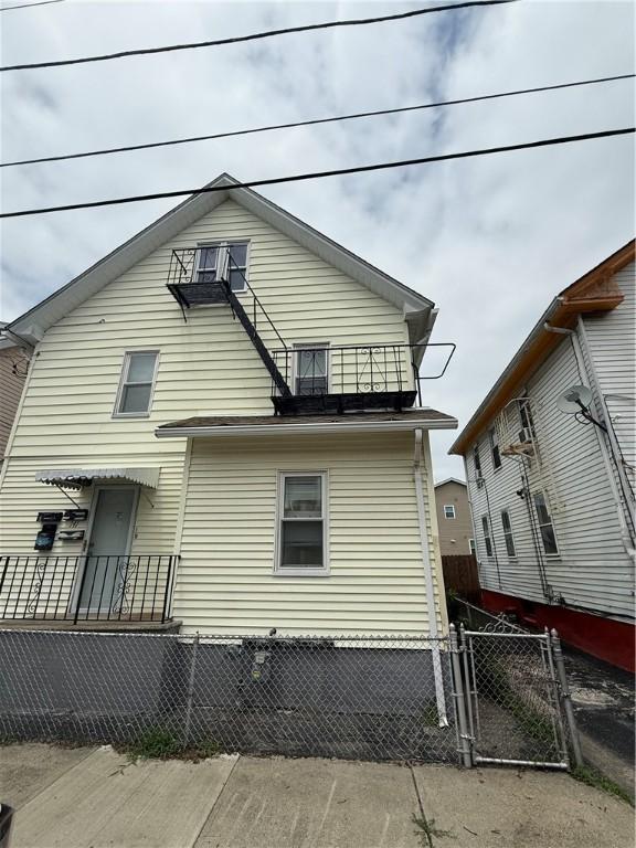 141 Pomona Ave, Providence, RI 02908 - rear view of house featuring a balcony and a gate