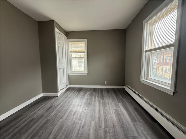 141 Pomona Ave, Providence, RI 02908 - unfurnished bedroom featuring baseboard heating and dark wood-type flooring