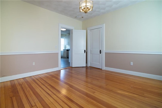 1397 Chalkstone Ave, Providence, RI 02909 - empty room with a chandelier and light wood finished floors