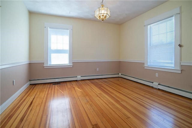 1397 Chalkstone Ave, Providence, RI 02909 - spare room featuring light wood-type flooring, a chandelier, and baseboard heating
