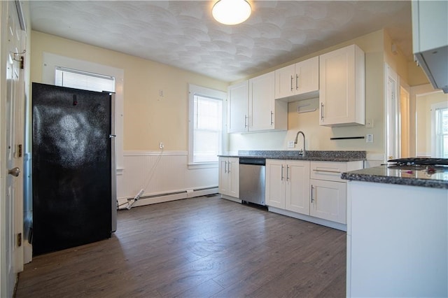 1397 Chalkstone Ave, Providence, RI 02909 - kitchen featuring stainless steel appliances, a baseboard radiator, healthy amount of natural light, white cabinetry, and wainscoting