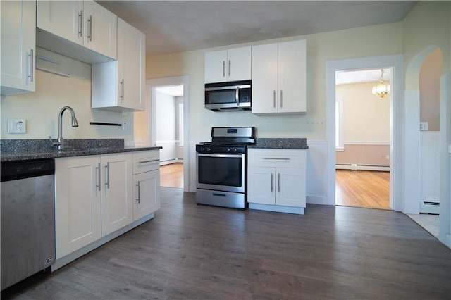1397 Chalkstone Ave, Providence, RI 02909 - kitchen featuring stainless steel appliances, a baseboard heating unit, white cabinetry, dark wood-style flooring, and a chandelier