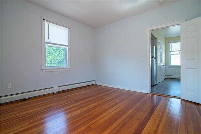 1397 Chalkstone Ave, Providence, RI 02909 - spare room with baseboard heating and wood finished floors