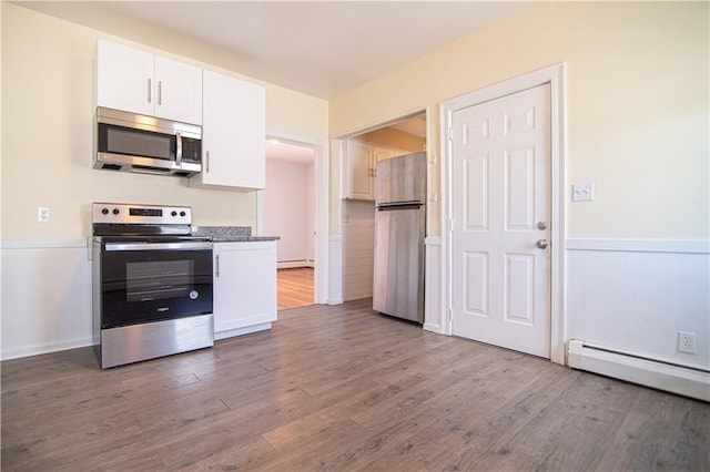 1397 Chalkstone Ave, Providence, RI 02909 - kitchen with appliances with stainless steel finishes, white cabinets, a baseboard heating unit, dark wood-style flooring, and baseboard heating