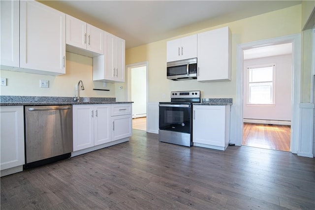 1397 Chalkstone Ave, Providence, RI 02909 - kitchen featuring appliances with stainless steel finishes, white cabinets, dark wood-style flooring, baseboard heating, and dark stone counters