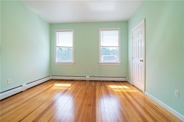 1397 Chalkstone Ave, Providence, RI 02909 - spare room with healthy amount of natural light, light wood-type flooring, and a baseboard heating unit
