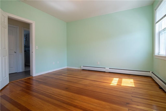 1397 Chalkstone Ave, Providence, RI 02909 - unfurnished room featuring wood finished floors and a baseboard heating unit