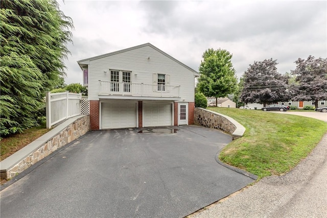 11 Macintosh Dr, Smithfield, RI 02828 - view of side of home with brick siding, a garage, a balcony, asphalt driveway, and a lawn