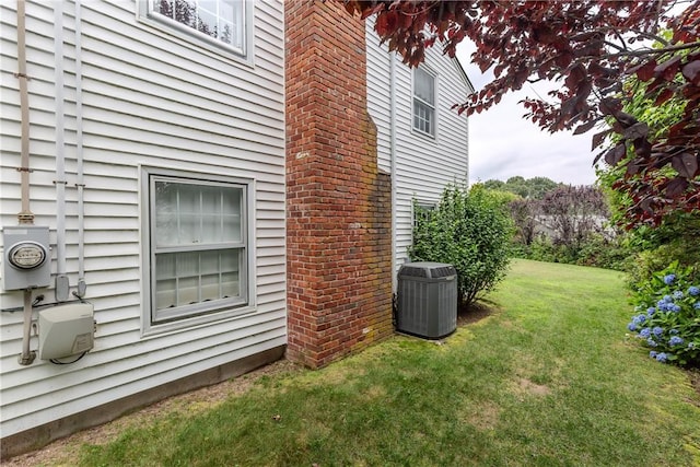 11 Macintosh Dr, Smithfield, RI 02828 - view of side of home with a central air condition unit and a yard