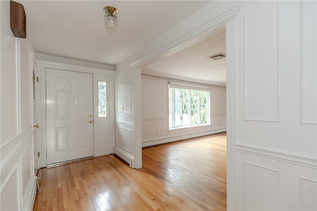11 Macintosh Dr, Smithfield, RI 02828 - entryway featuring light wood-type flooring, baseboard heating, and a decorative wall