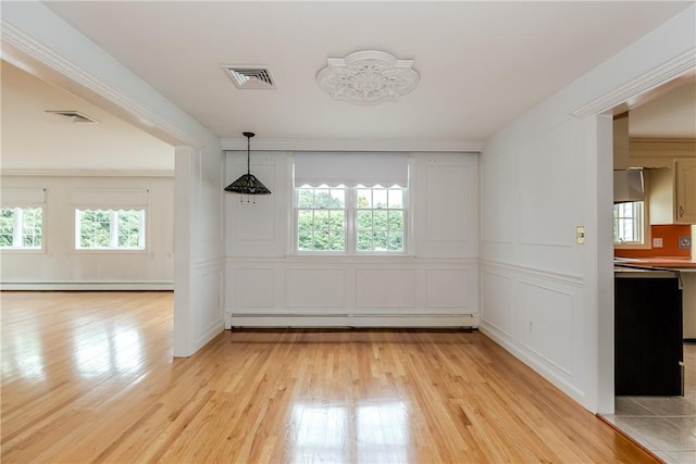11 Macintosh Dr, Smithfield, RI 02828 - unfurnished dining area with a decorative wall, a baseboard heating unit, baseboard heating, and light wood-style floors