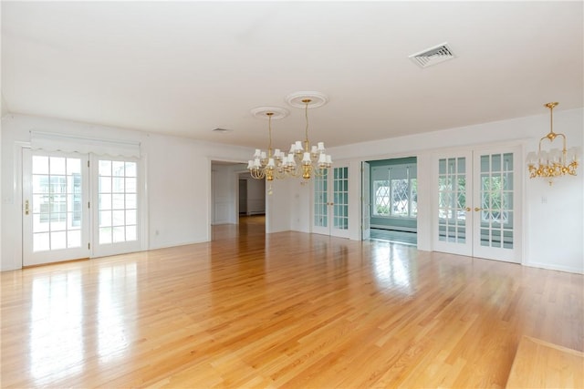 11 Macintosh Dr, Smithfield, RI 02828 - empty room with a chandelier, french doors, and light wood-type flooring