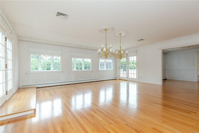 11 Macintosh Dr, Smithfield, RI 02828 - empty room featuring a baseboard radiator, a chandelier, and light wood-style flooring