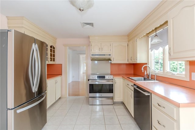 11 Macintosh Dr, Smithfield, RI 02828 - kitchen featuring stainless steel appliances, under cabinet range hood, light tile patterned floors, and cream cabinetry